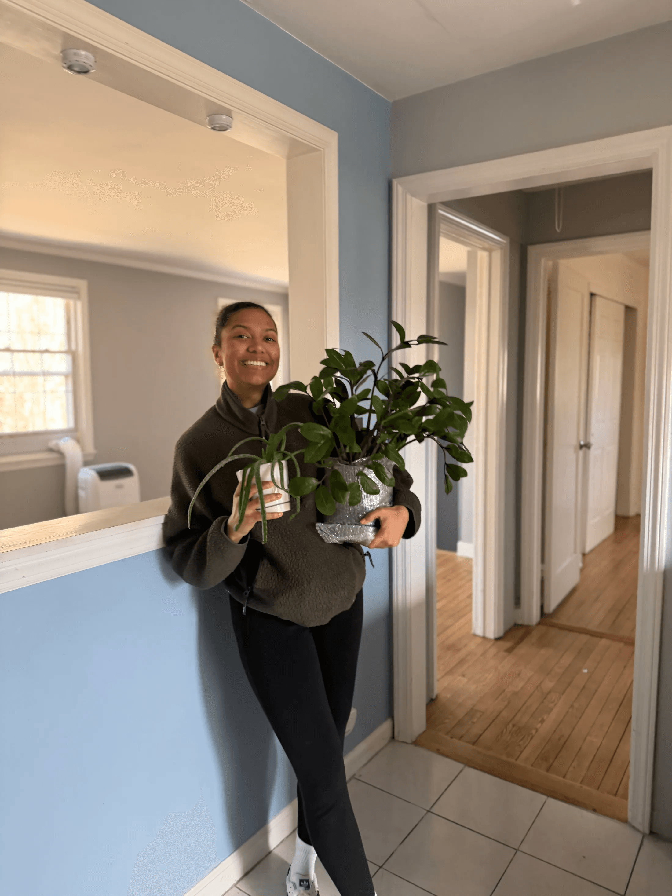 Customer holding plants after Mia's Jersey City move
